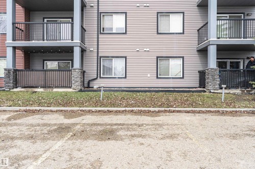 Multi-story building exterior featuring horizontal siding and dark-trimmed windows - 219 646 Mcallister Loop, Edmonton, AB - Outdoor With Balcony