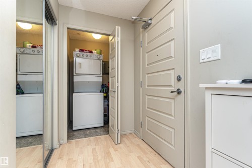 Entryway featuring light wood-finish flooring and a paneled door - 219 646 Mcallister Loop, Edmonton, AB - Indoor Photo Showing Other Room