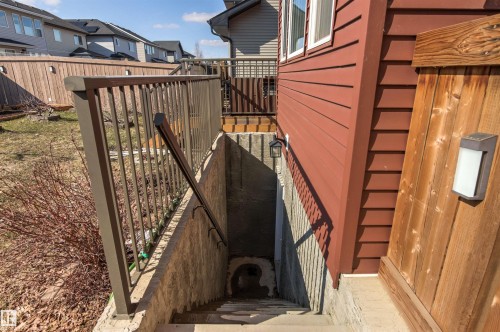 Exterior stairwell with concrete walls and steps, featuring a metal handrail and balusters - 9812 224 Street, Edmonton, AB - Outdoor With Exterior