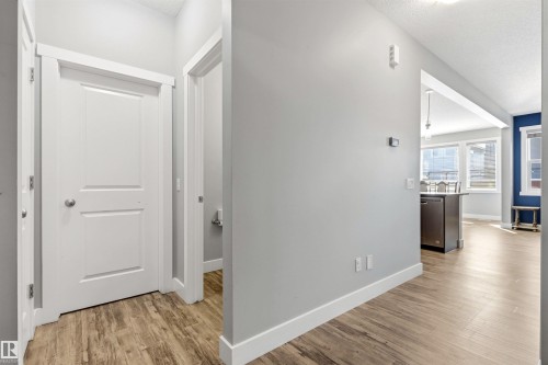 Hallway featuring wood-finish flooring, white baseboards, and a neutral wall color - 9812 224 Street, Edmonton, AB - Indoor Photo Showing Other Room