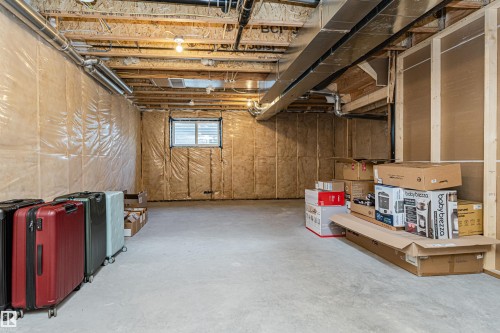 Unfinished basement featuring exposed wood joists, concrete flooring, and insulated walls - 3367 Erlanger Bend, Edmonton, AB - Indoor Photo Showing Basement