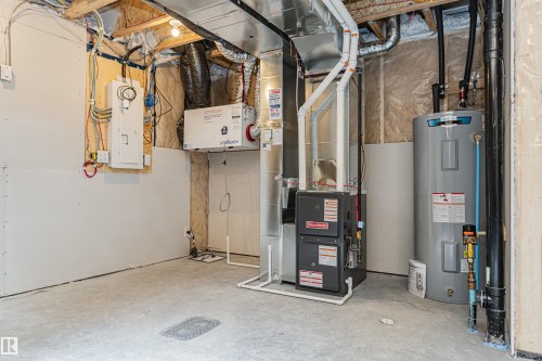 Dedicated utility area featuring a furnace, water heater, and ventilation system - 3367 Erlanger Bend, Edmonton, AB - Indoor Photo Showing Basement