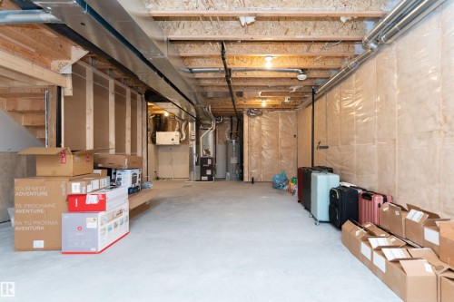 Unfinished basement with exposed wood joists and concrete flooring - 3367 Erlanger Bend, Edmonton, AB - Indoor Photo Showing Basement