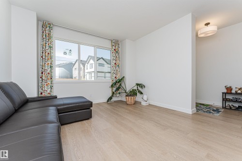 Bright interior space featuring light wood-finish flooring and white walls - 3367 Erlanger Bend, Edmonton, AB - Indoor Photo Showing Living Room