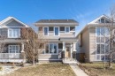 Two-story residence featuring light-toned horizontal siding, a dark shingle roof, and multiple windows - 16420 15 Avenue, Edmonton, AB  - Outdoor With Facade 