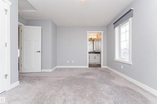 Spacious room featuring light gray walls, plush gray carpeting, and white trim - 16420 15 Avenue, Edmonton, AB - Indoor Photo Showing Other Room