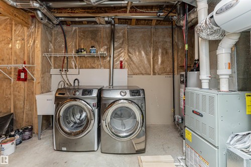 Utility area featuring concrete flooring, a utility sink, and visible HVAC system - 16420 15 Avenue, Edmonton, AB - Indoor Photo Showing Laundry Room