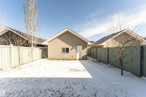 Detached garage with horizontal siding, a single entry door, and a window - 16420 15 Avenue, Edmonton, AB - Outdoor
