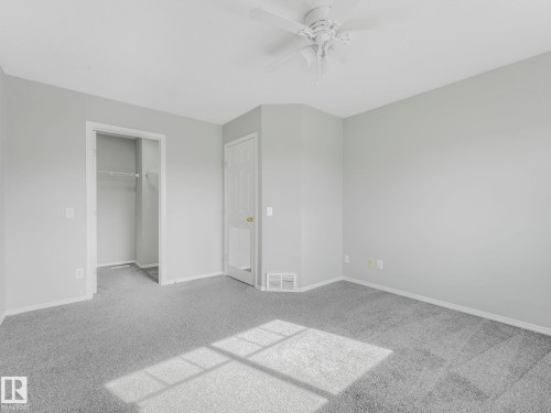 This room features light grey walls and grey carpet flooring, offering a neutral palette - 175 150 Edwards Drive, Edmonton, AB - Indoor Photo Showing Other Room
