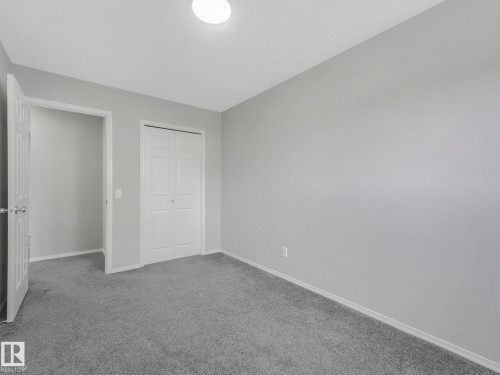 This room features grey walls, grey carpeting, and white trim - 175 150 Edwards Drive, Edmonton, AB - Indoor Photo Showing Other Room