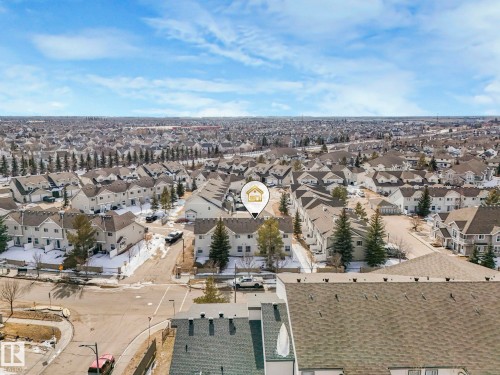Aerial view of the surrounding neighborhood, featuring residential properties with pitched roofs and a street network - 175 150 Edwards Drive, Edmonton, AB - Outdoor With View