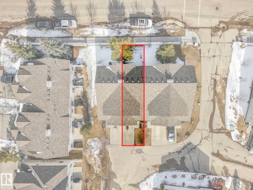 Aerial view showcasing the property's roofline, driveway, and surrounding grounds - 175 150 Edwards Drive, Edmonton, AB - 