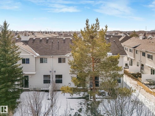 The property features a multi-story exterior with light-colored siding and a dark roof - 175 150 Edwards Drive, Edmonton, AB - Outdoor