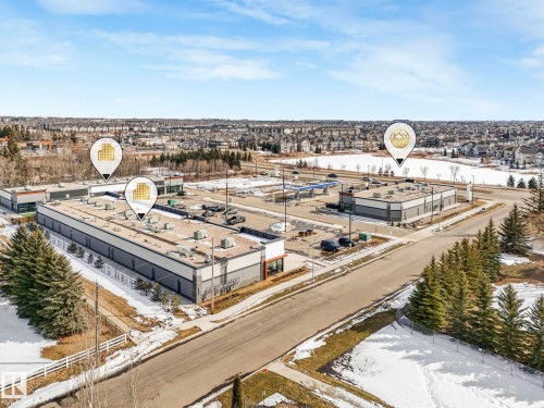 Aerial view showcasing a commercial building with a large parking area - 175 150 Edwards Drive, Edmonton, AB - Outdoor With View