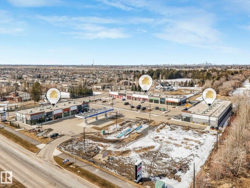 Aerial view showcasing commercial properties with paved parking areas and surrounding roadways - 175 150 Edwards Drive, Edmonton, AB - Outdoor With View