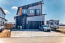 Contemporary multi-level exterior featuring dark paneling, wood-finish siding, and light vertical siding accents - 5263 47 Ave, Calmar, AB  - Outdoor 