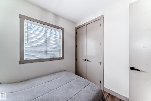 Crisp white walls frame a window with blinds, complemented by gray trim - 5263 47 Ave, Calmar, AB - Indoor Photo Showing Bedroom