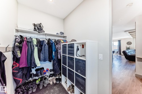 Entryway featuring a built-in closet system with shelving and hanging rods, recessed lighting, and wood-finish flooring - 5263 47 Ave, Calmar, AB - Indoor Photo Showing Other Room