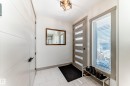 Entryway featuring white rectangular floor tiles and a contemporary flush mount light fixture - 5263 47 Ave, Calmar, AB  - Indoor Photo Showing Other Room 