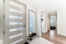 Modern entryway featuring a grey door with horizontal glass inserts, a full-length sidelight with blinds, and recessed lighting - 5263 47 Ave, Calmar, AB  - Indoor Photo Showing Other Room 