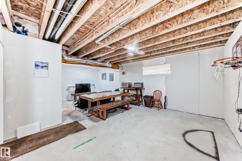 Unfinished basement space featuring exposed wood joists and visible utility lines - 5263 47 Ave, Calmar, AB - Indoor Photo Showing Basement