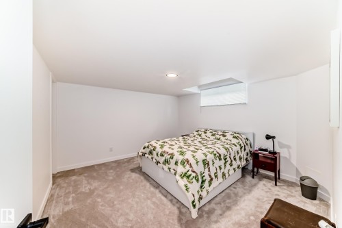 Neutral tone carpeted room featuring white walls, recessed lighting, and a white trim finish - 5263 47 Ave, Calmar, AB - Indoor Photo Showing Bedroom