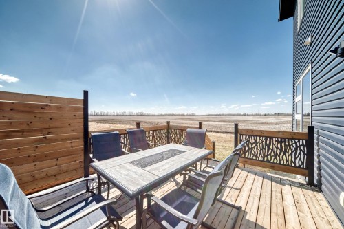 Spacious wood-finish deck featuring a privacy screen and decorative metal railing - 5263 47 Ave, Calmar, AB - Outdoor With Deck Patio Veranda With Exterior