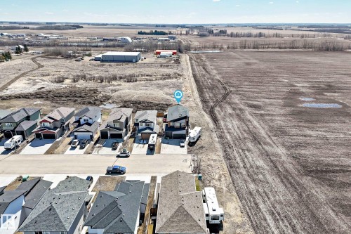 Aerial perspective showcasing the property's position at the end of a residential street, bordering expansive agricultural land - 5263 47 Ave, Calmar, AB - Outdoor With View