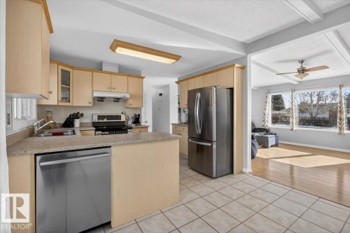 Kitchen featuring light wood cabinetry, stainless steel appliances, and a tile backsplash - 13508 81 Street, Edmonton, AB - Indoor Photo Showing Kitchen