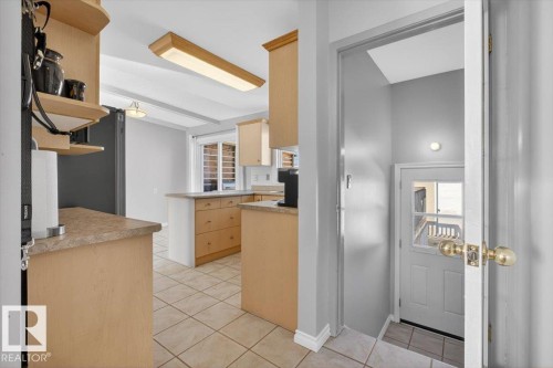 Kitchen with light wood cabinetry, light-toned countertops, and tile flooring - 13508 81 Street, Edmonton, AB - Indoor Photo Showing Other Room