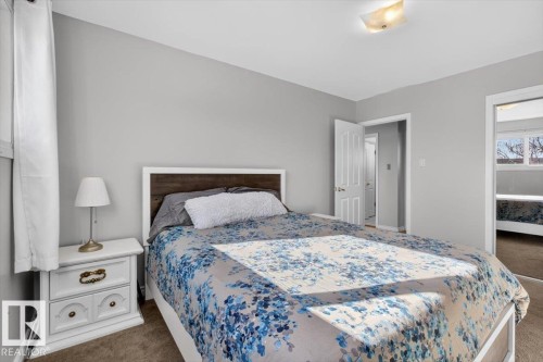 Carpeted bedroom with neutral wall tones and a white trimmed window - 13508 81 Street, Edmonton, AB - Indoor Photo Showing Bedroom