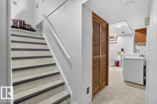Staircase with tile treads and safety strips, leading to a utility area - 13508 81 Street, Edmonton, AB - Indoor Photo Showing Laundry Room