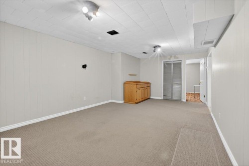 Carpeted room featuring white paneled walls and a drop ceiling with recessed lighting - 13508 81 Street, Edmonton, AB - Indoor Photo Showing Other Room