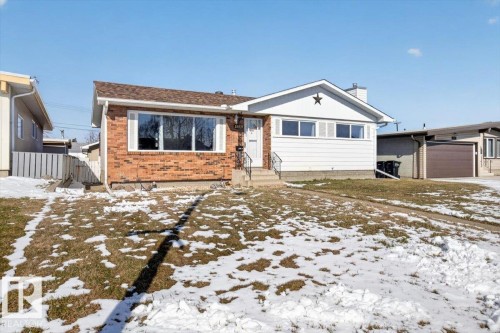 Single-story residence featuring a brick facade, white siding, and a brown shingle roof - 13508 81 Street, Edmonton, AB - Outdoor