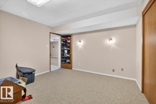Carpeted room with neutral-toned walls, featuring a drop ceiling with a central flush-mount light fixture - 13508 81 Street, Edmonton, AB - Indoor Photo Showing Other Room