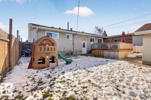 Expansive backyard featuring a wood privacy fence, a multi-level wood deck with slatted wood screening, and a rear exterior with multiple windows - 13508 81 Street, Edmonton, AB - Outdoor With Deck Patio Veranda
