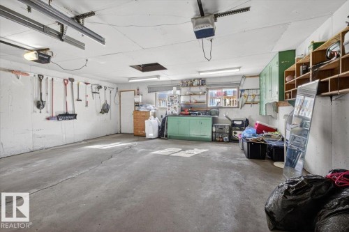 Spacious garage with concrete flooring and exposed ceiling joists - 13508 81 Street, Edmonton, AB - Indoor Photo Showing Garage