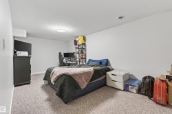Carpeted room with white walls and a ceiling-mounted flush light fixture - 