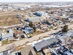 Residential neighborhood featuring a grid-pattern street layout, individual detached homes with varied rooflines, and paved roads - 