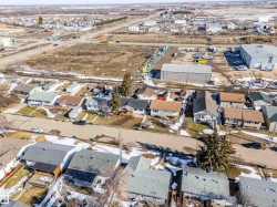 Aerial perspective showcasing a residential street with single-story homes - 
