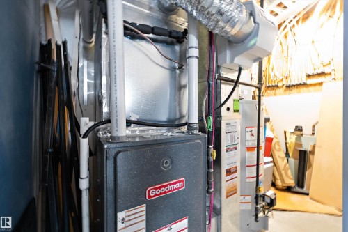 Goodman furnace and water heater installation with visible PVC piping and flexible ductwork - 1586 Chapman Way, Edmonton, AB - Indoor Photo Showing Basement
