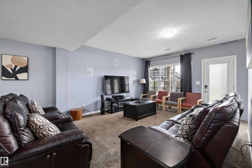 Spacious living area featuring light blue walls and a neutral carpet - 1586 Chapman Way, Edmonton, AB - Indoor Photo Showing Living Room
