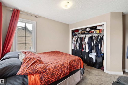 Comfortable room featuring a window with white trim, neutral-toned walls, and soft carpet flooring - 1586 Chapman Way, Edmonton, AB - Indoor Photo Showing Bedroom
