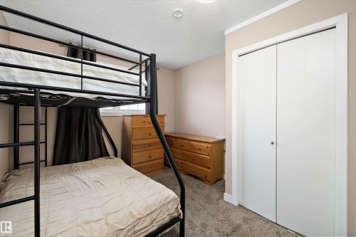 Neutral-toned walls complement the textured gray carpeting - 1586 Chapman Way, Edmonton, AB - Indoor Photo Showing Bedroom