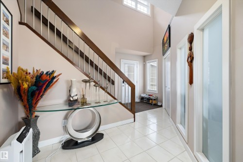 Two-story foyer featuring a staircase with wood-finish handrails and metal balusters - 1586 Chapman Way, Edmonton, AB - Indoor Photo Showing Other Room