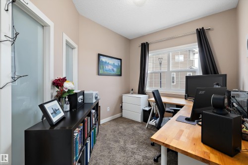 Versatile room featuring a large window with dark drapery, light brown walls, and plush carpeting - 1586 Chapman Way, Edmonton, AB - Indoor Photo Showing Office