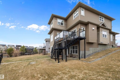 Multi-level exterior with tan siding and white trim windows - 1586 Chapman Way, Edmonton, AB - Outdoor