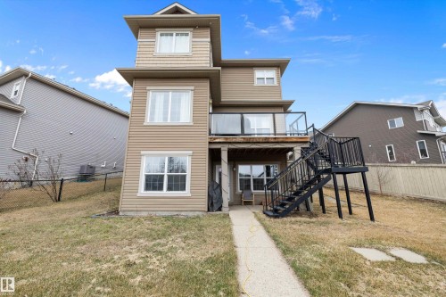 Multi-level residence featuring beige horizontal siding and white-trimmed windows - 1586 Chapman Way, Edmonton, AB - Outdoor