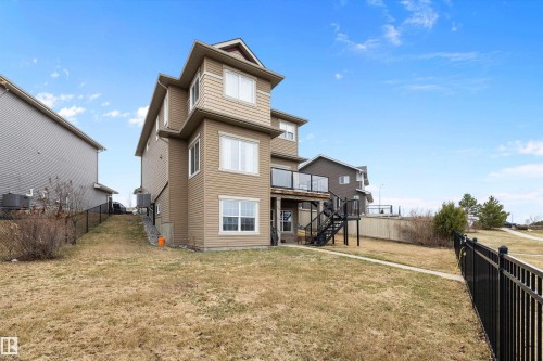 Multi-level residence featuring a rear deck with glass panel railing and exterior stairs - 1586 Chapman Way, Edmonton, AB - Outdoor With Exterior