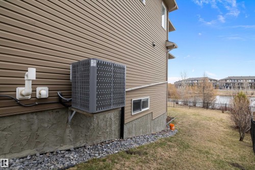 Exterior wall with horizontal siding, gravel landscaping, and a visible HVAC unit - 1586 Chapman Way, Edmonton, AB - Outdoor